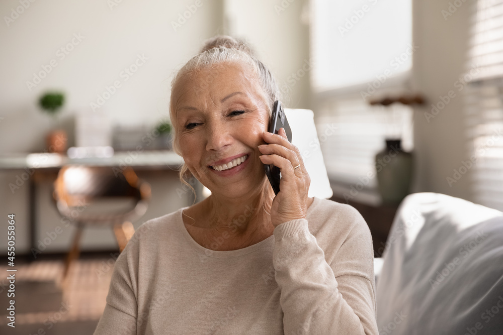 Senior woman smiling and enjoying a phone conversation